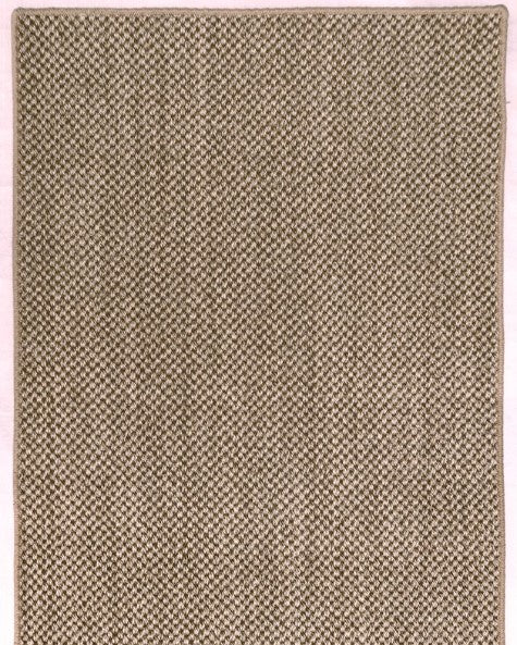 Beige woven rug with a subtle pattern on a plain background
