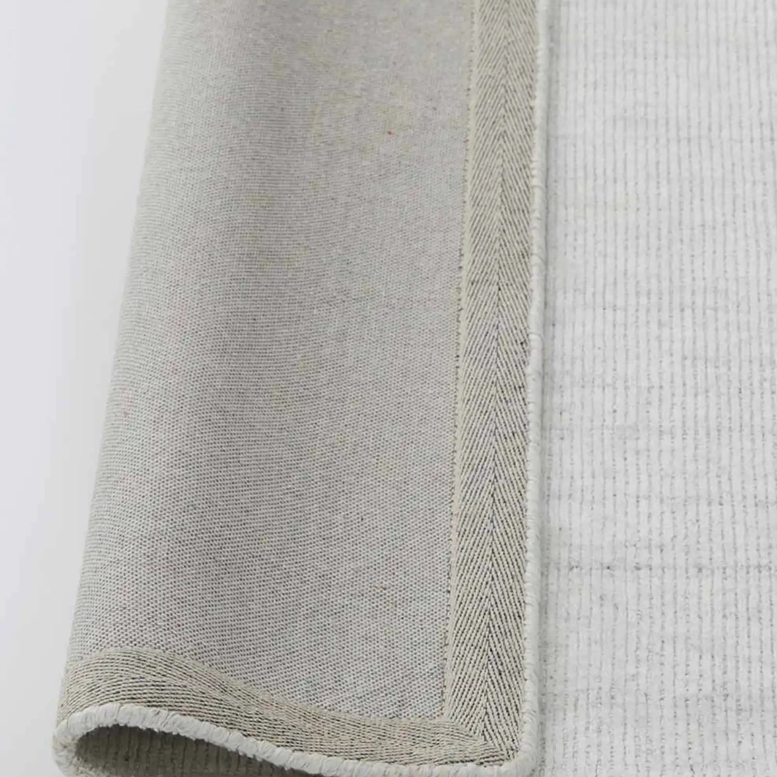 Edge and backing detail of the Travertine Rug, showcasing its quality construction and durable design.