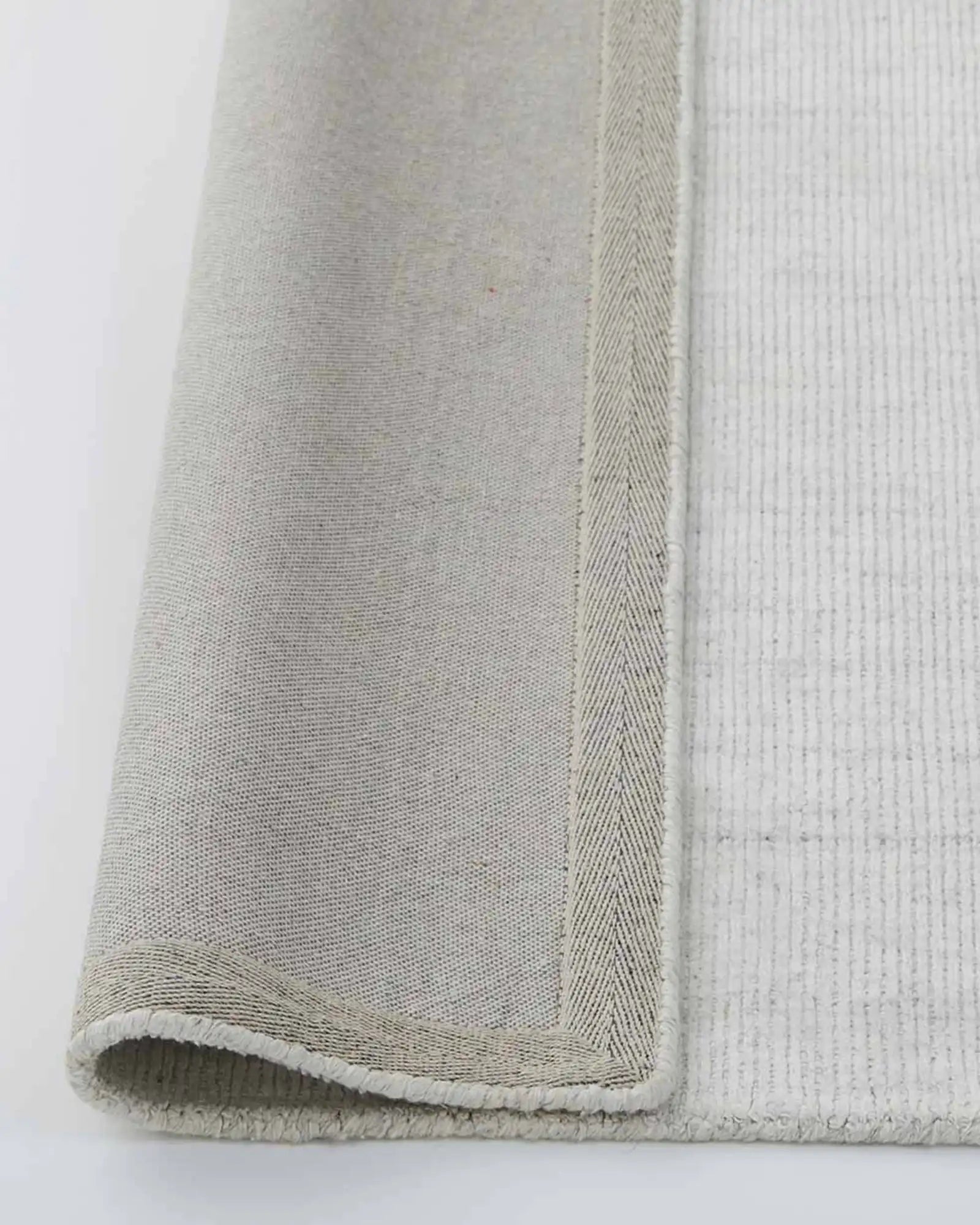 Edge and backing detail of the Travertine Rug, showcasing its quality construction and durable design.