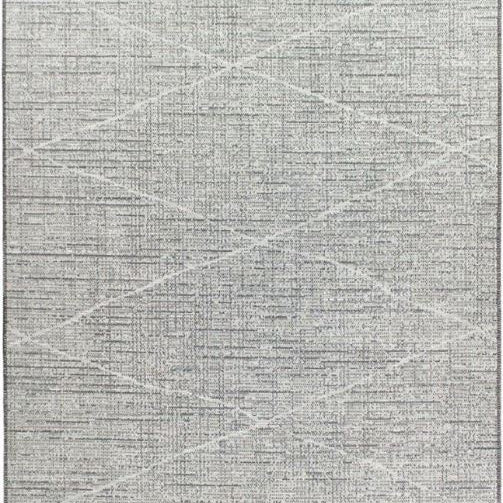 Gray area rug with geometric pattern and tassels on a plain background