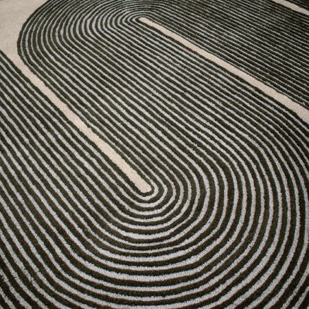 Close-up of a black and white patterned rug with concentric circles.