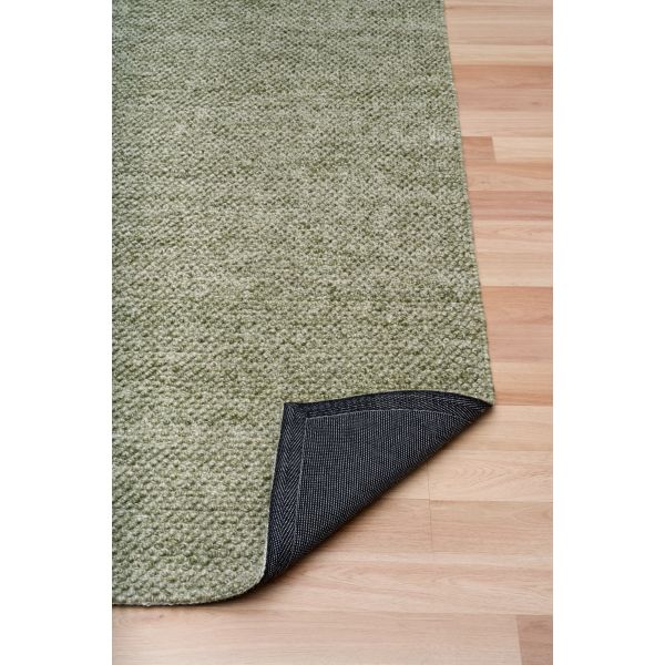 Avenue pesto rug showing cotton backing on timber flooring