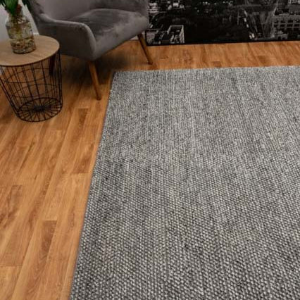 Elegant Avenue Rug displayed in a modern living room, showcasing its grey and natural tones that beautifully complement contemporary home decor.