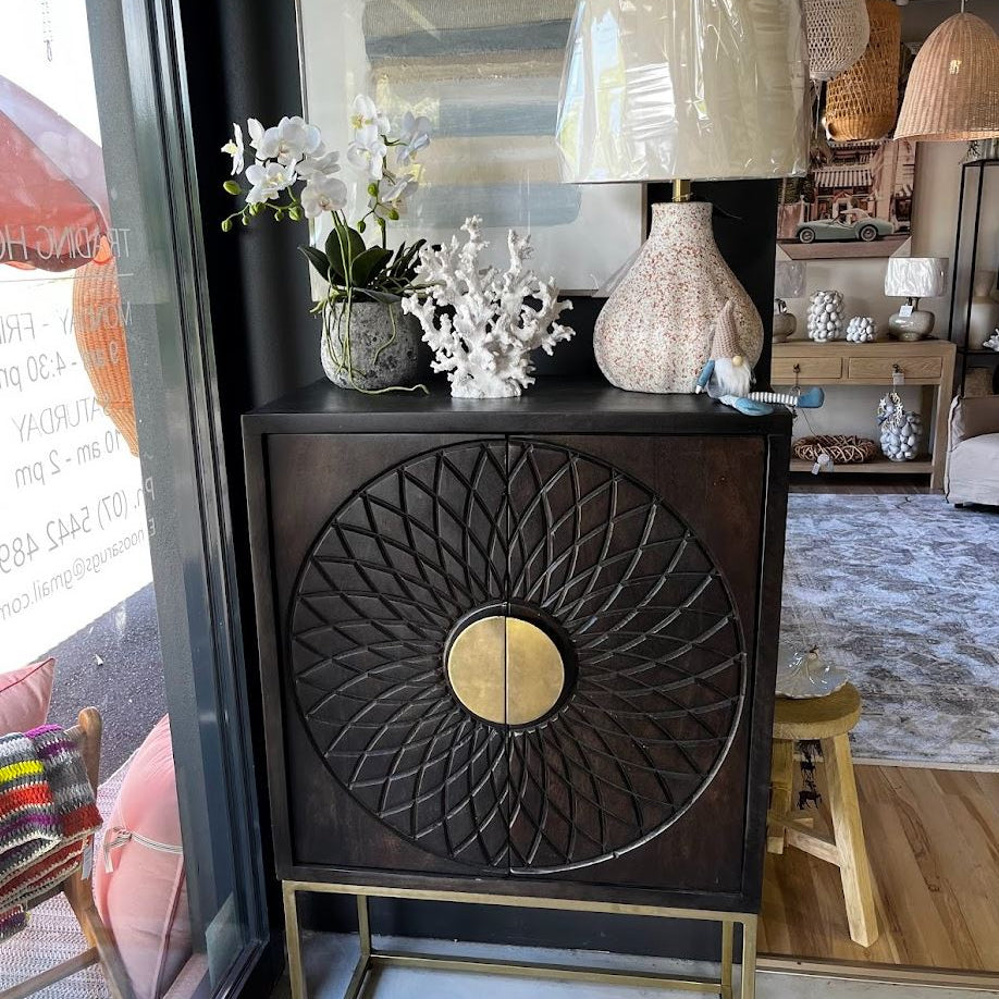 Decorative cabinet with intricate design in a home setting