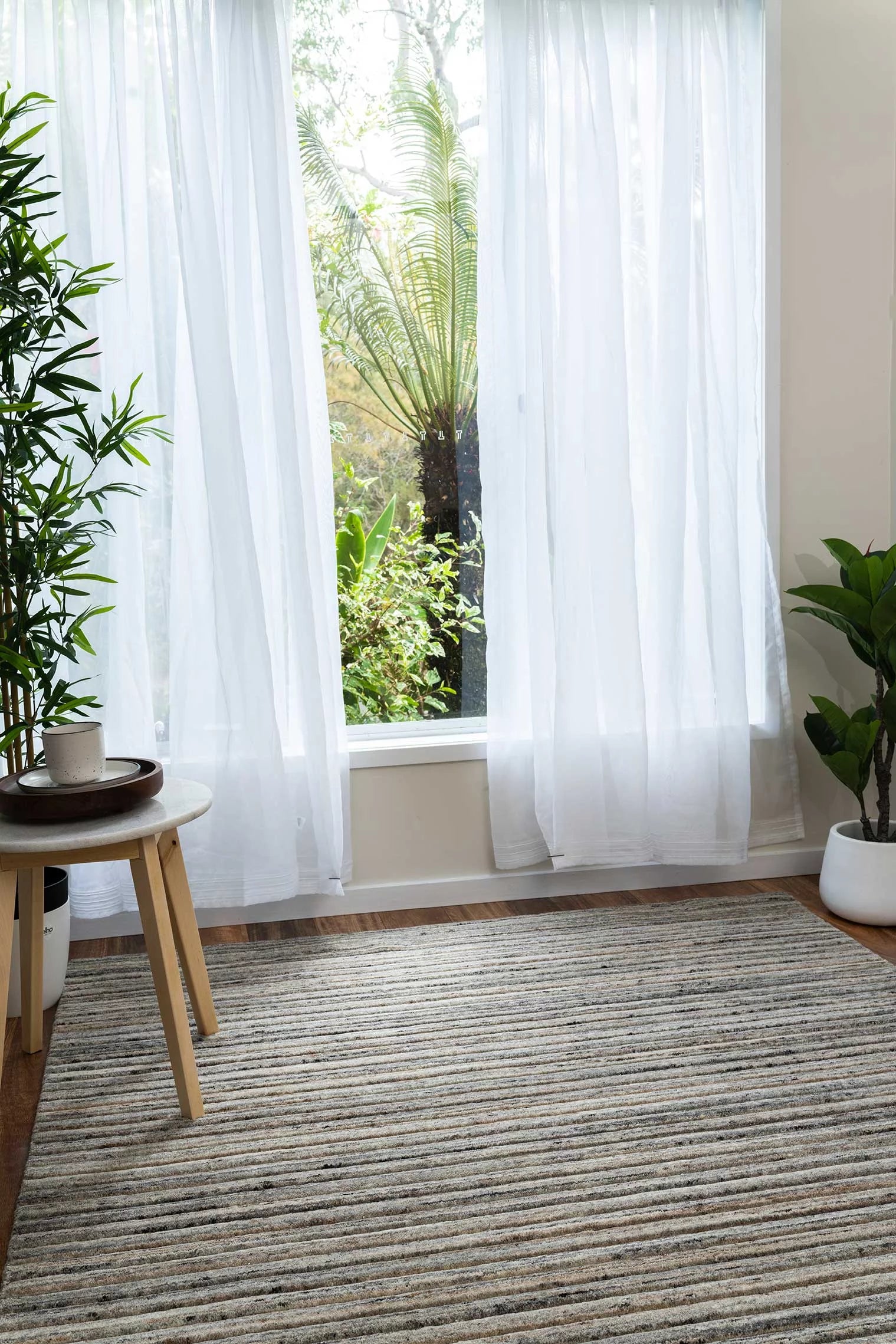 Focusing on the rug's handloom-knotted craftsmanship, this image captures the precision and quality inherent in its 80% New Zealand wool and 20% cotton composition.