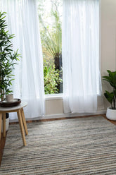 Focusing on the rug's handloom-knotted craftsmanship, this image captures the precision and quality inherent in its 80% New Zealand wool and 20% cotton composition.