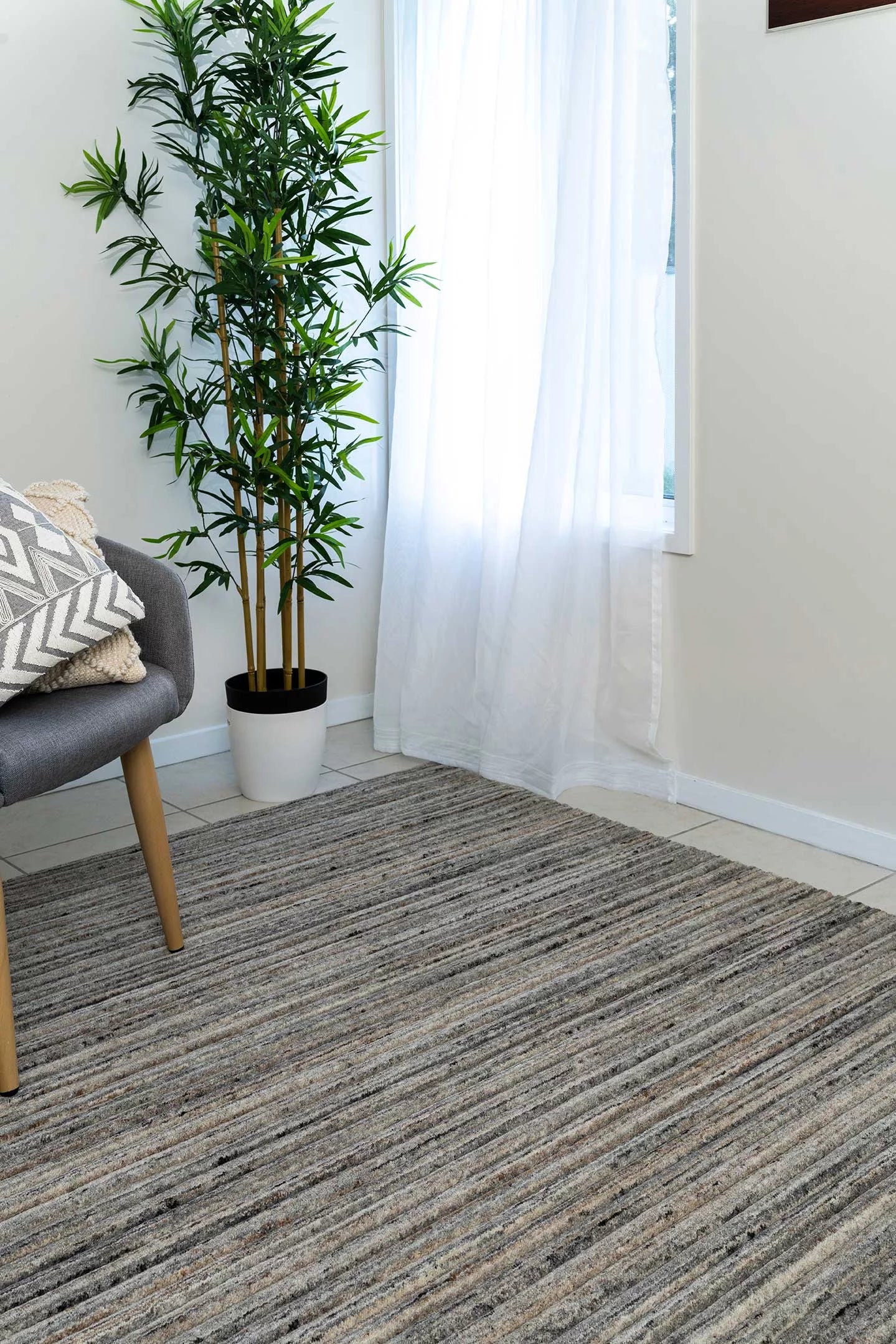 This image highlights the detailed grooved pattern and high-low finish of the rug, showcasing the luxurious texture and subtle tonal variations in the American Walnut colour.