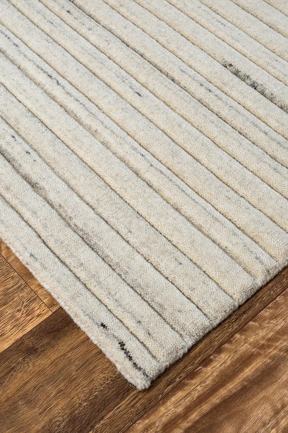 An image portraying the rug in a well-appointed room, highlighting how its rustic charm and French Garlic colour add sophistication to contemporary interiors.