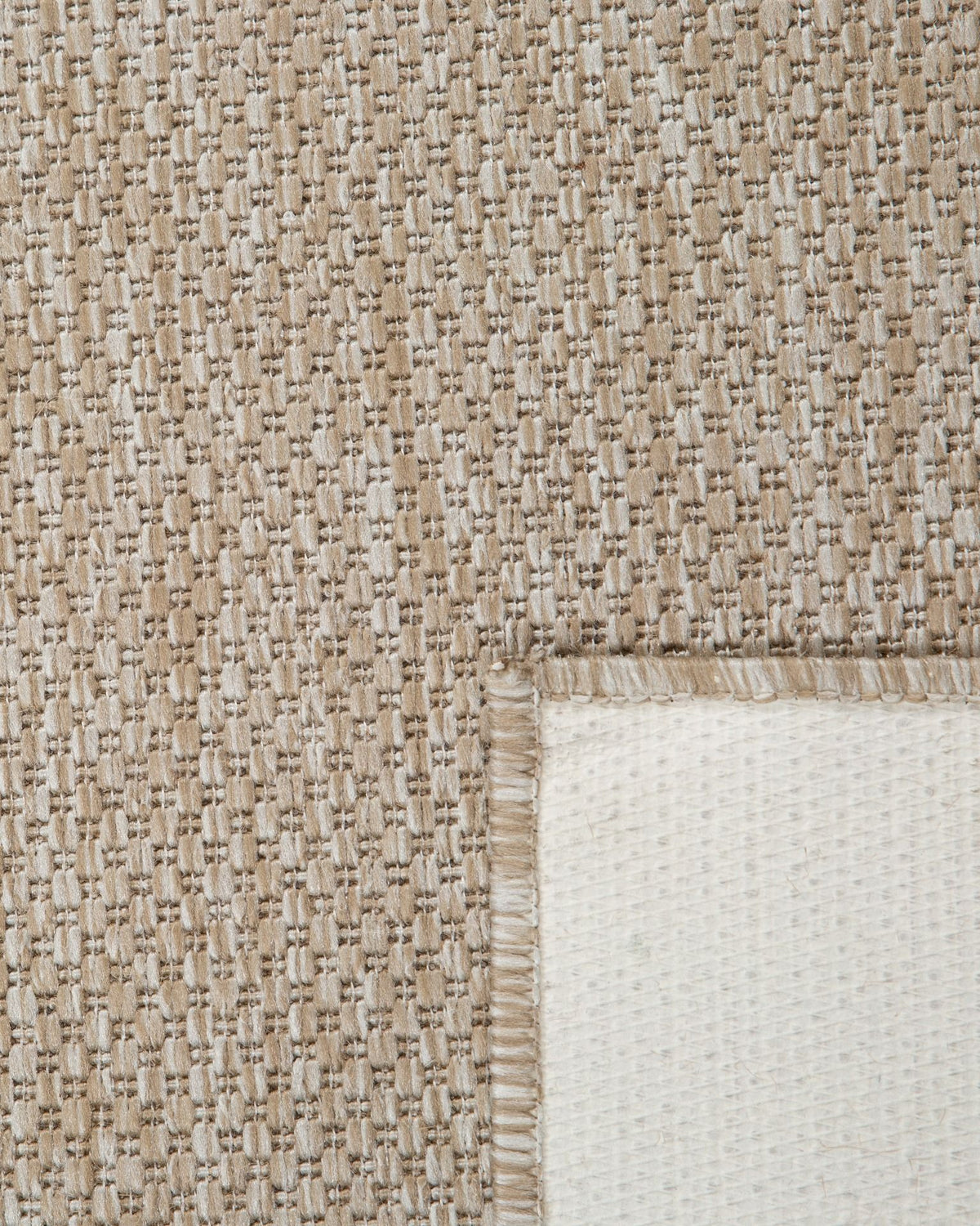 The latex backing of the chino sand rug o