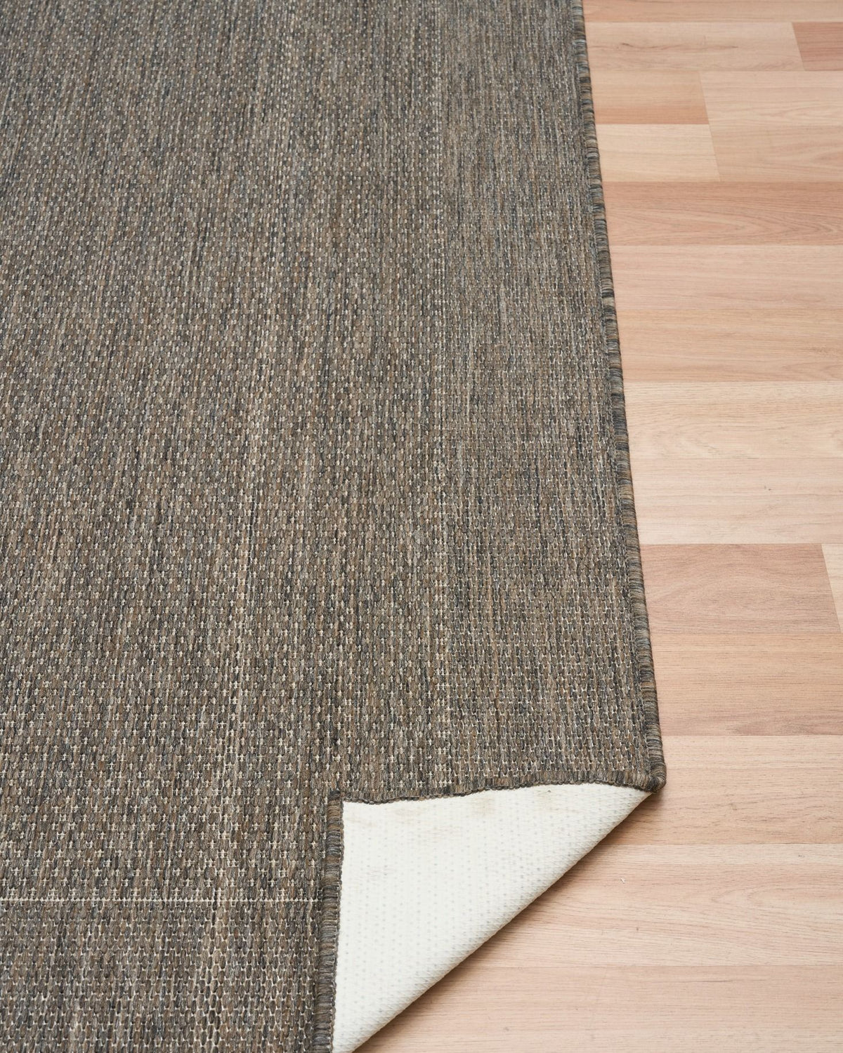 Chino rug showing its latex backing on a timber floor