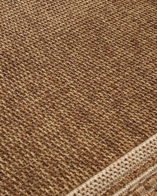 Close-up of a brown textured fabric with a geometric pattern