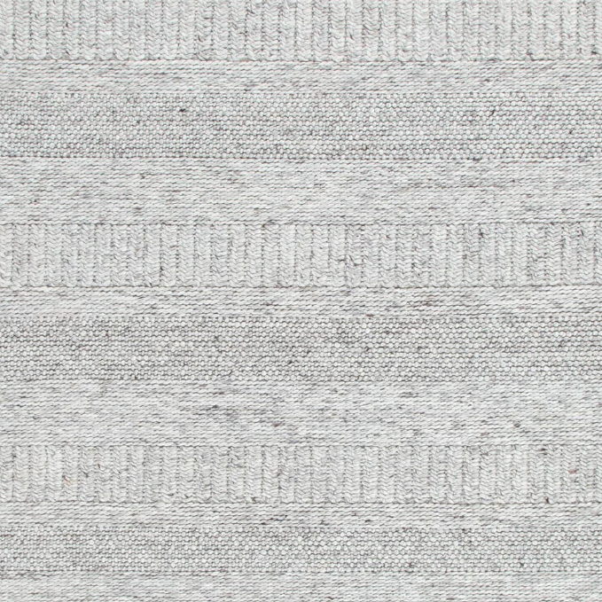 Close-up view of a grey wool and nylon area rug with a textured pattern