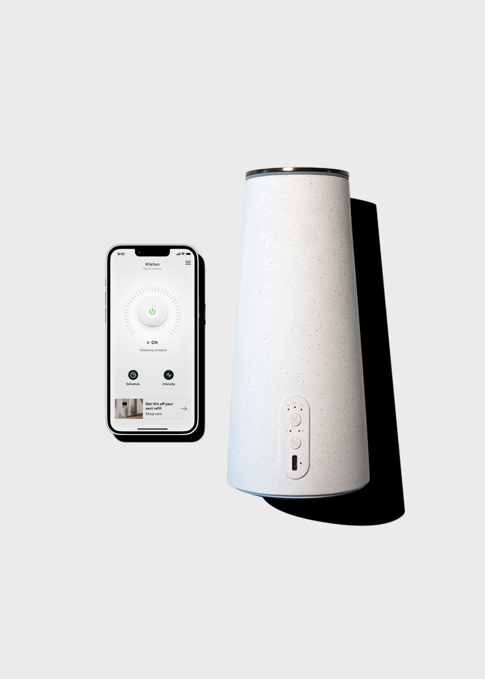 White humidifier with smartphone displaying humidifier app on a light gray background