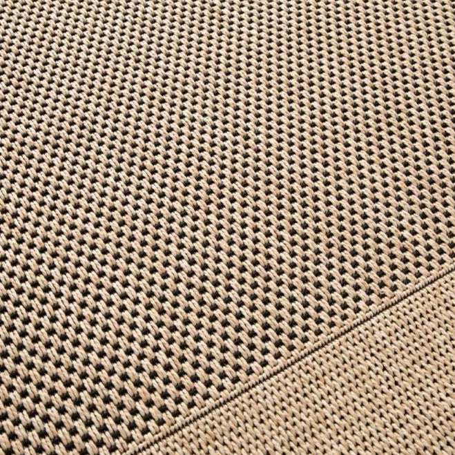 Close-up of a textured beige fabric with a diamond pattern
