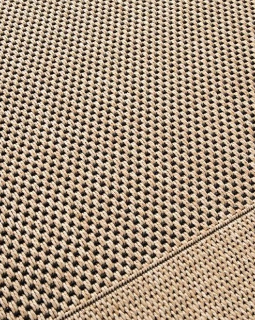 Close-up of a textured beige fabric with a diamond pattern