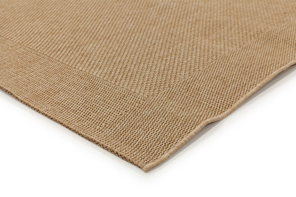 Close-up of a beige woven mat on a white background