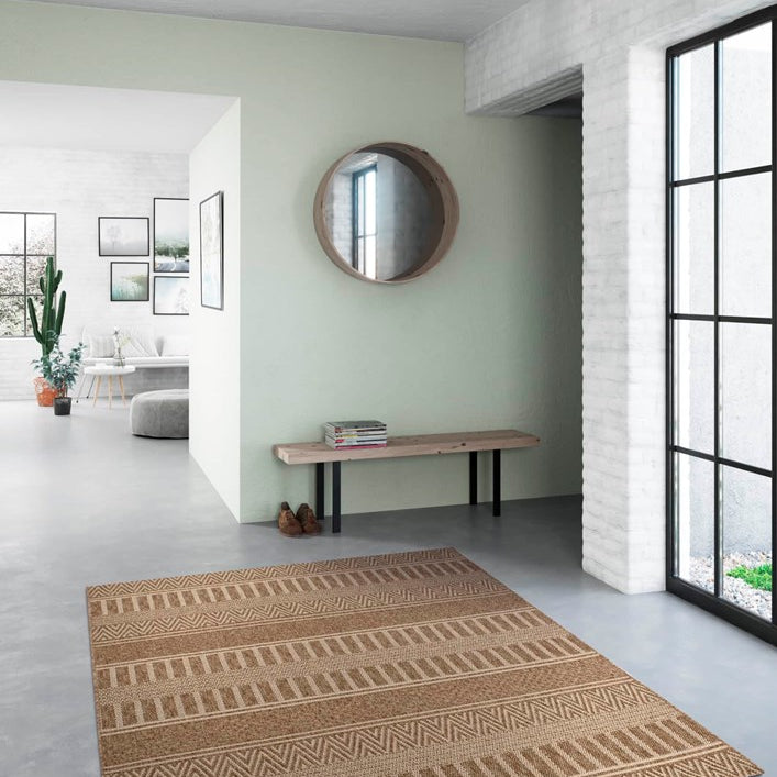 Patterned rug on a gray floor with a light green wall and large window.