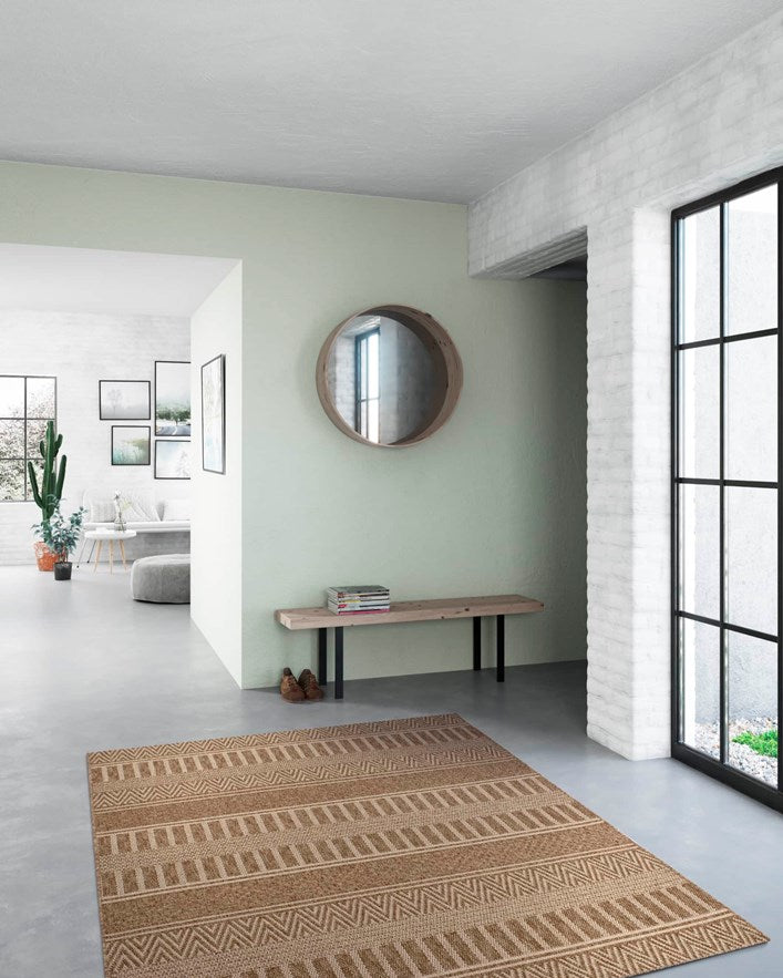Patterned rug on a gray floor with a light green wall and large window.