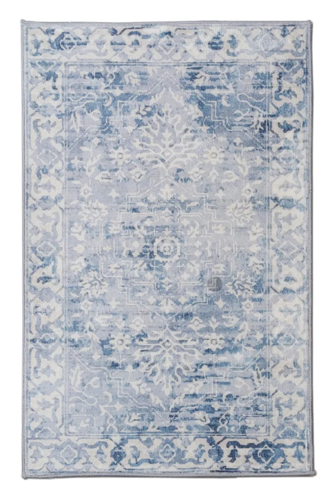Decorative rug with blue and white pattern on a plain background