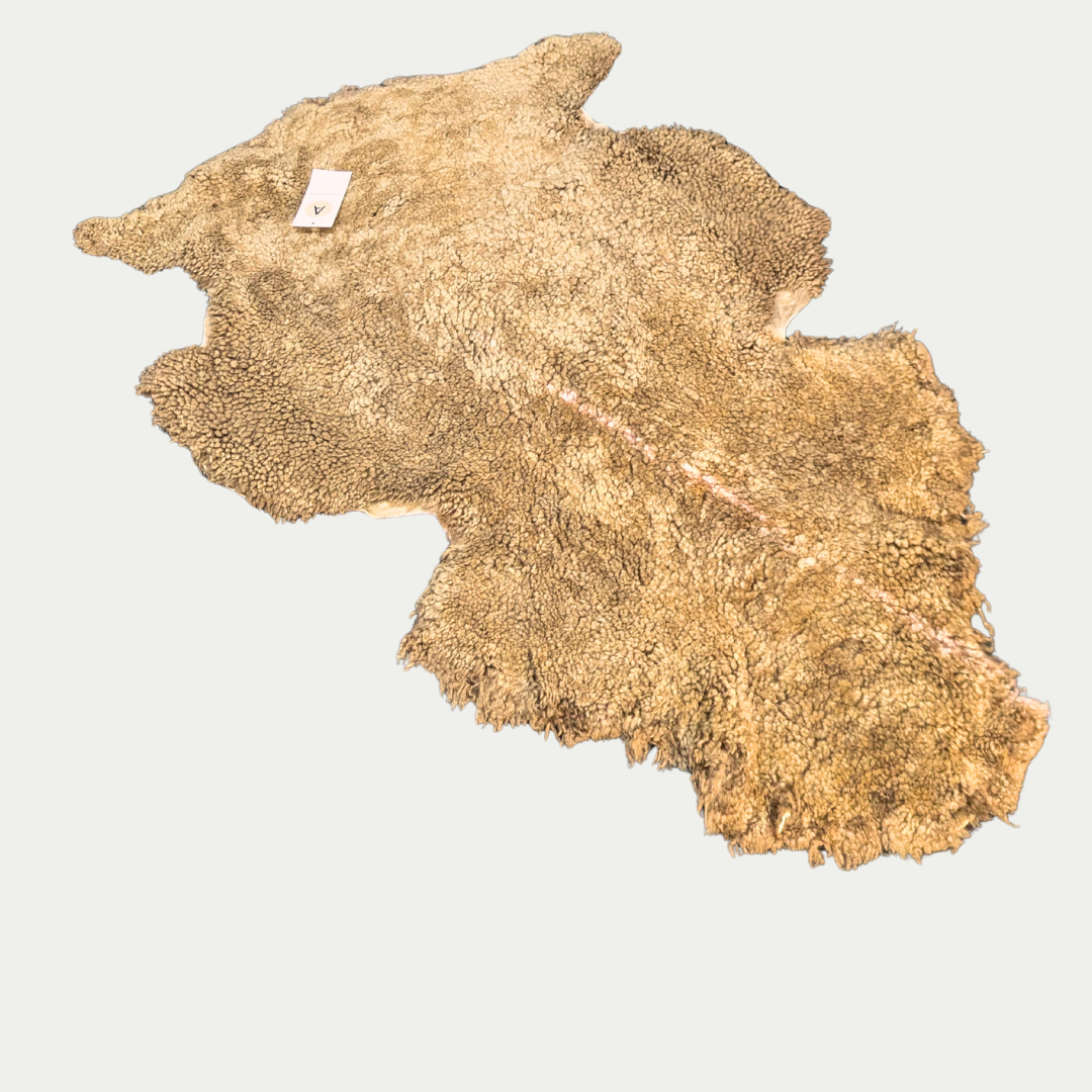 Dark pet sheepskin rug on white background