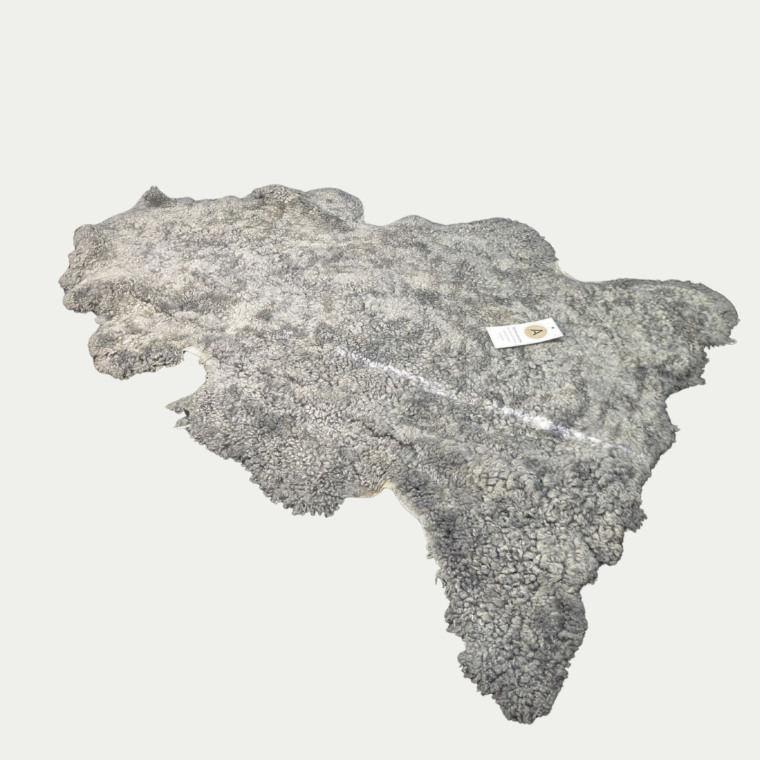 Grey sheepskin pet rug on white background