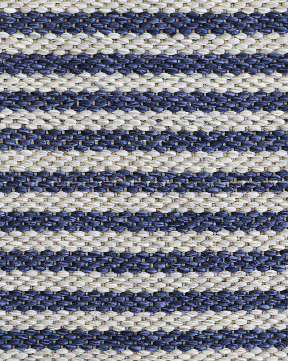 A close-up of a woven textile with horizontal stripes in navy blue and warm off-white, showing the detailed texture of the fibers.