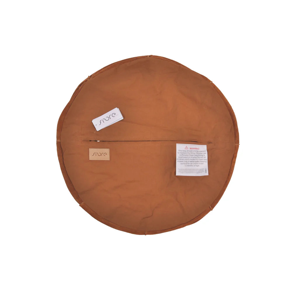 Round brown cushion with visible brand labels on a white background