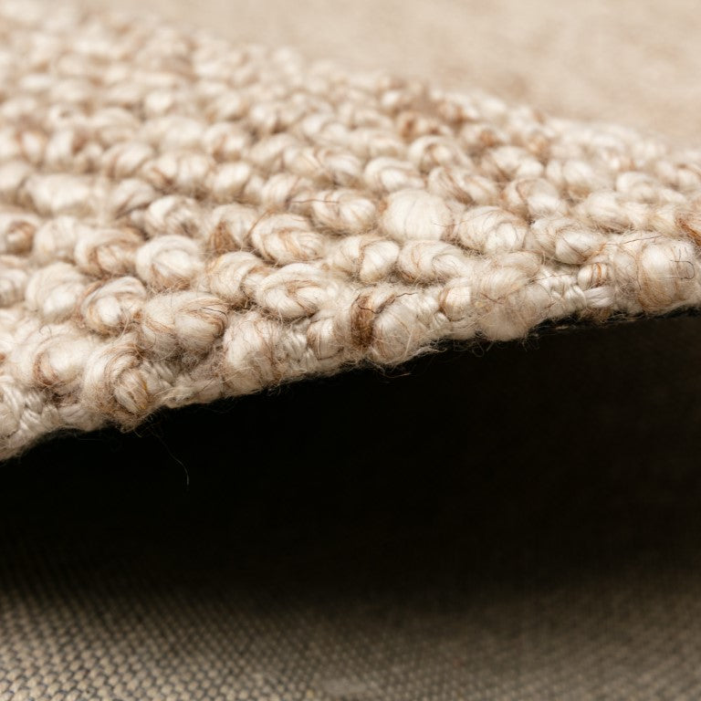 Artisanal Avenue Rug in a natural beige shade, portraying the blend of traditional hand weaving techniques with contemporary design.