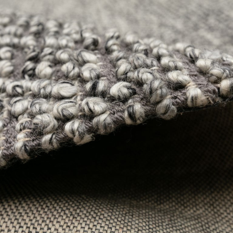 Detailed view of the Avenue Rug's handwoven craftsmanship and plush pile, emphasizing the quality and comfort it brings to eco-conscious interiors.