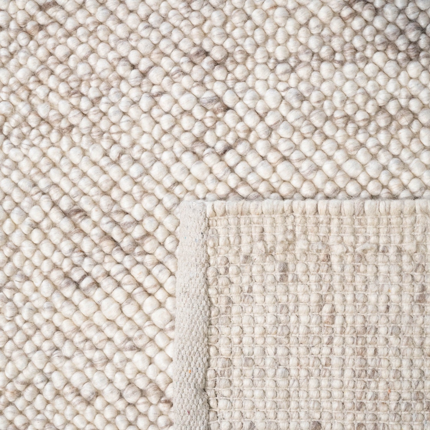 Sophisticated Almond-colored LUNAR Rug displayed in a modern home setting, adding a touch of timeless elegance to the room's decor.