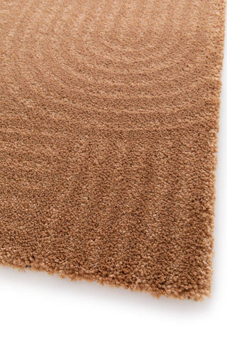 Close-up of a brown textured rug corner on a white background