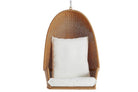 Wicker hanging chair with a white cushion on a white background