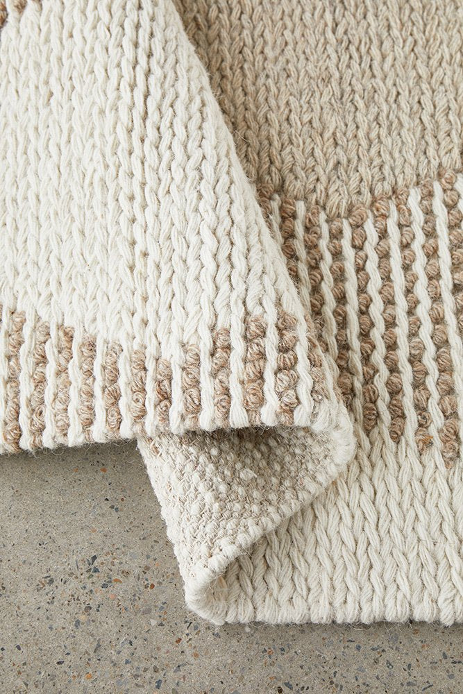hand woven rug that is on polished concrete