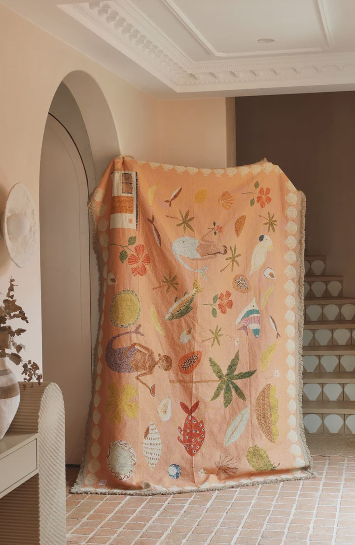 Colorful children's rug with animal patterns on a tiled floor.