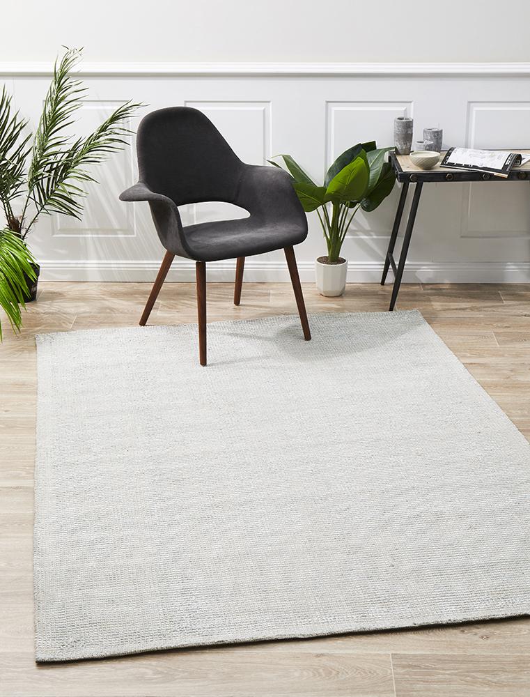 The Allure Rug in Sky colour displayed in a living room, demonstrating how it complements and enriches contemporary decor with its calming tones.