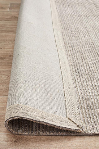 The Allure Rug in Stone colour rolled up, revealing the consistency of the weave and the underside quality, demonstrating its durability and ease of handling.