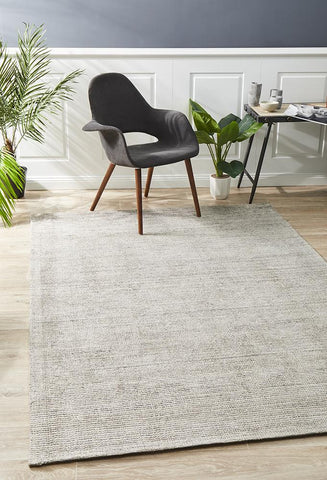 The Allure Rug in Stone colour elegantly placed in a room, showcasing its ability to complement and enhance modern and traditional decor alike.