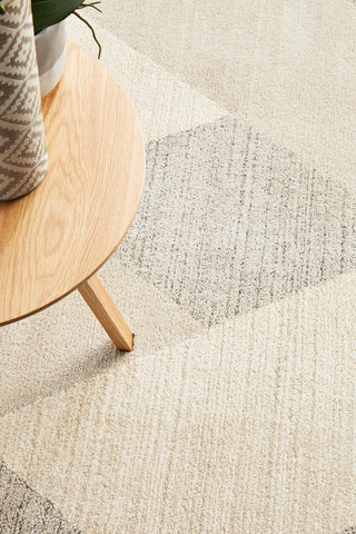 Detailed close-up of the Alpine Rug's geometric patterns, highlighting the sleek shapes and the subtle interplay of grey tones.