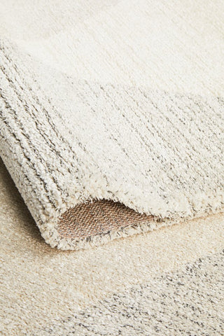 The Alpine Collection Rug rolled up, demonstrating its durability and flexibility, suitable for easy transport and redecoration.