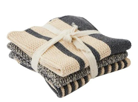 Stack of folded checkered towels tied with a ribbon on a white background