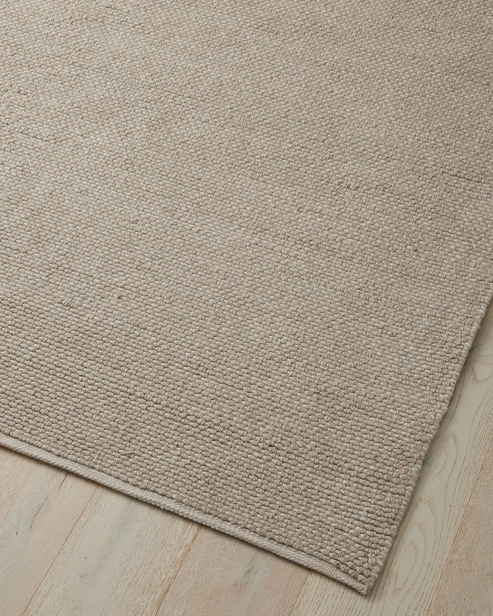 Detail of the Andorra Oatmeal rug's durable weave, showcasing its suitability for high-traffic areas and resistance to the elements.