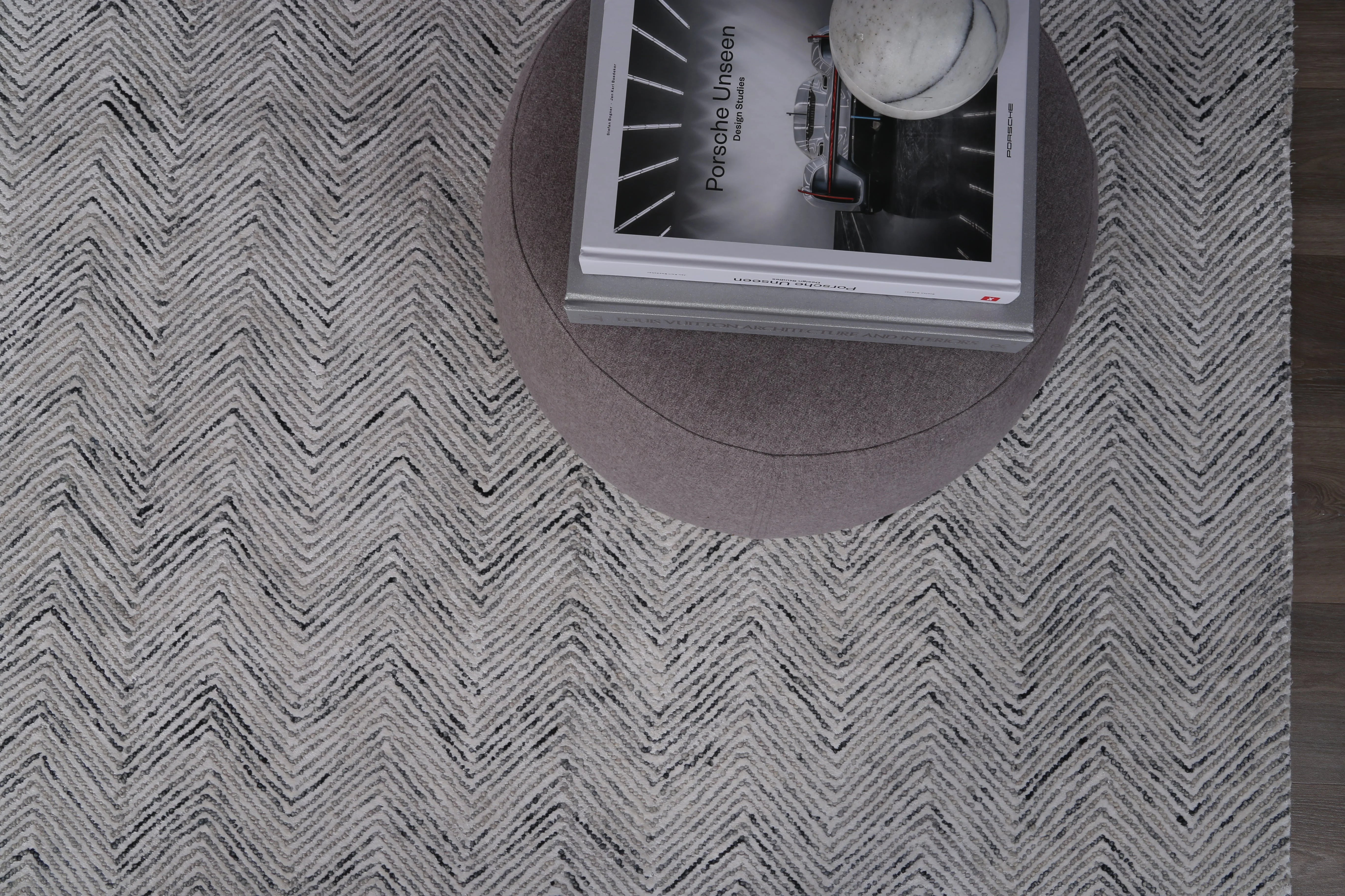 Image showing how light reflects off the Astrid Rug's viscose fibers, creating a dynamic and shifting depth of colour.