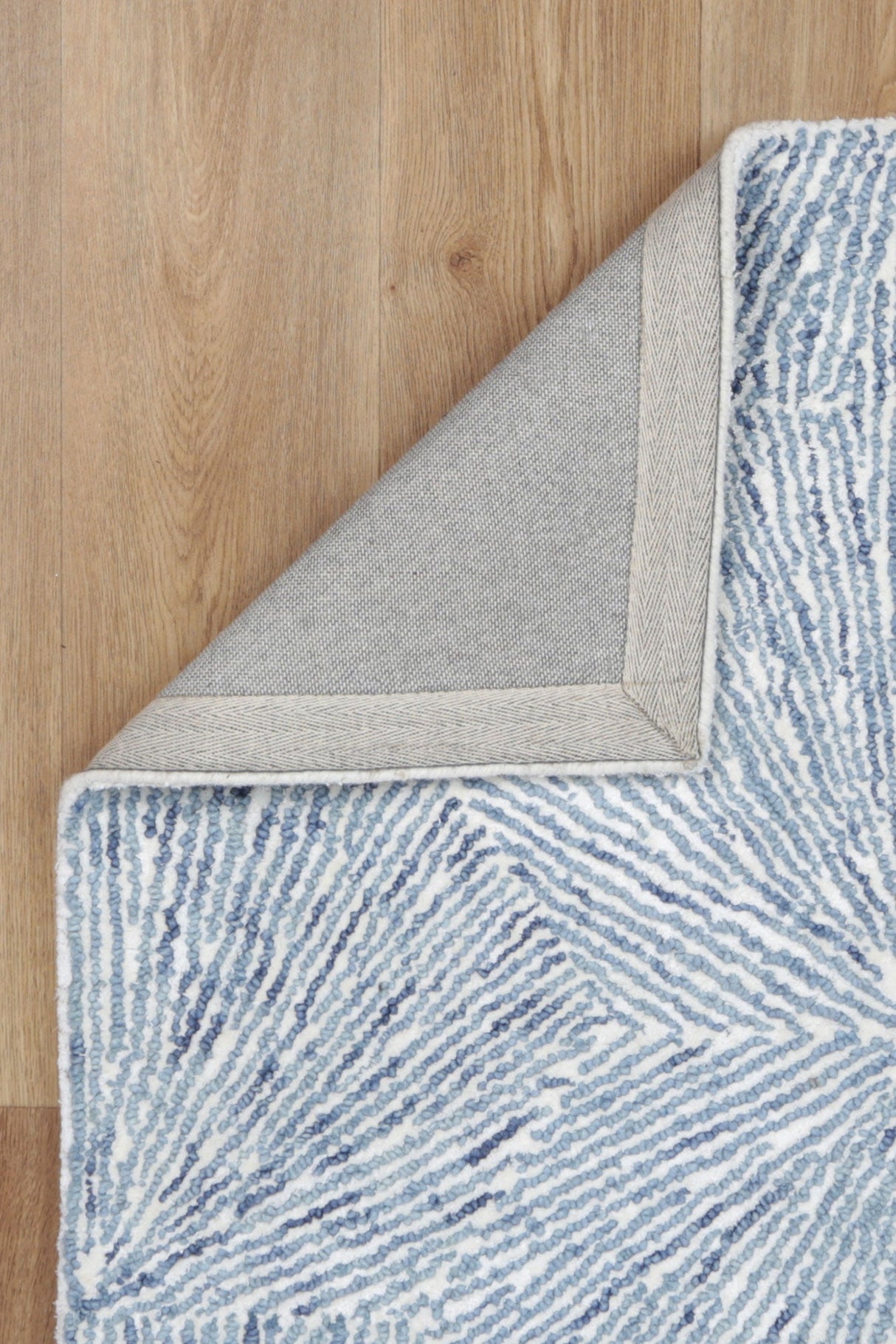 Astrid Hexagon Blue Rug backing on timber flooring