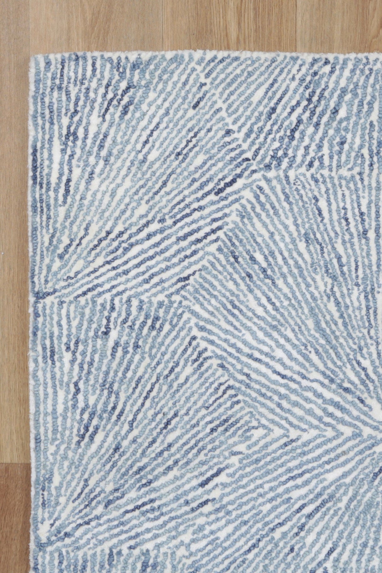 Astrid Hexagon Blue Rug on timber flooring
