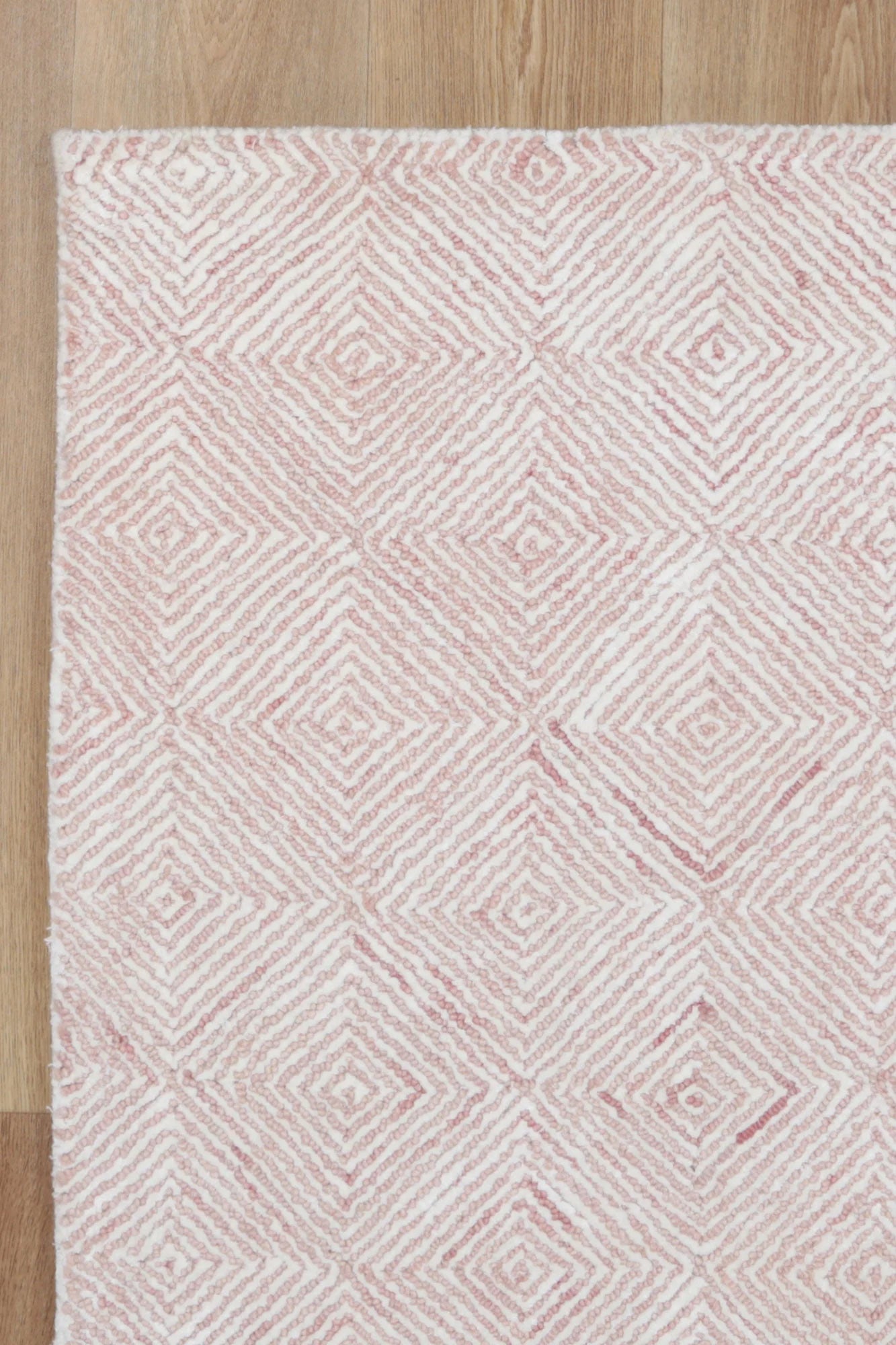 Detailed close-up of the Astrid Blush Rug's texture, emphasizing the softness and quality of the wool and viscose blend.