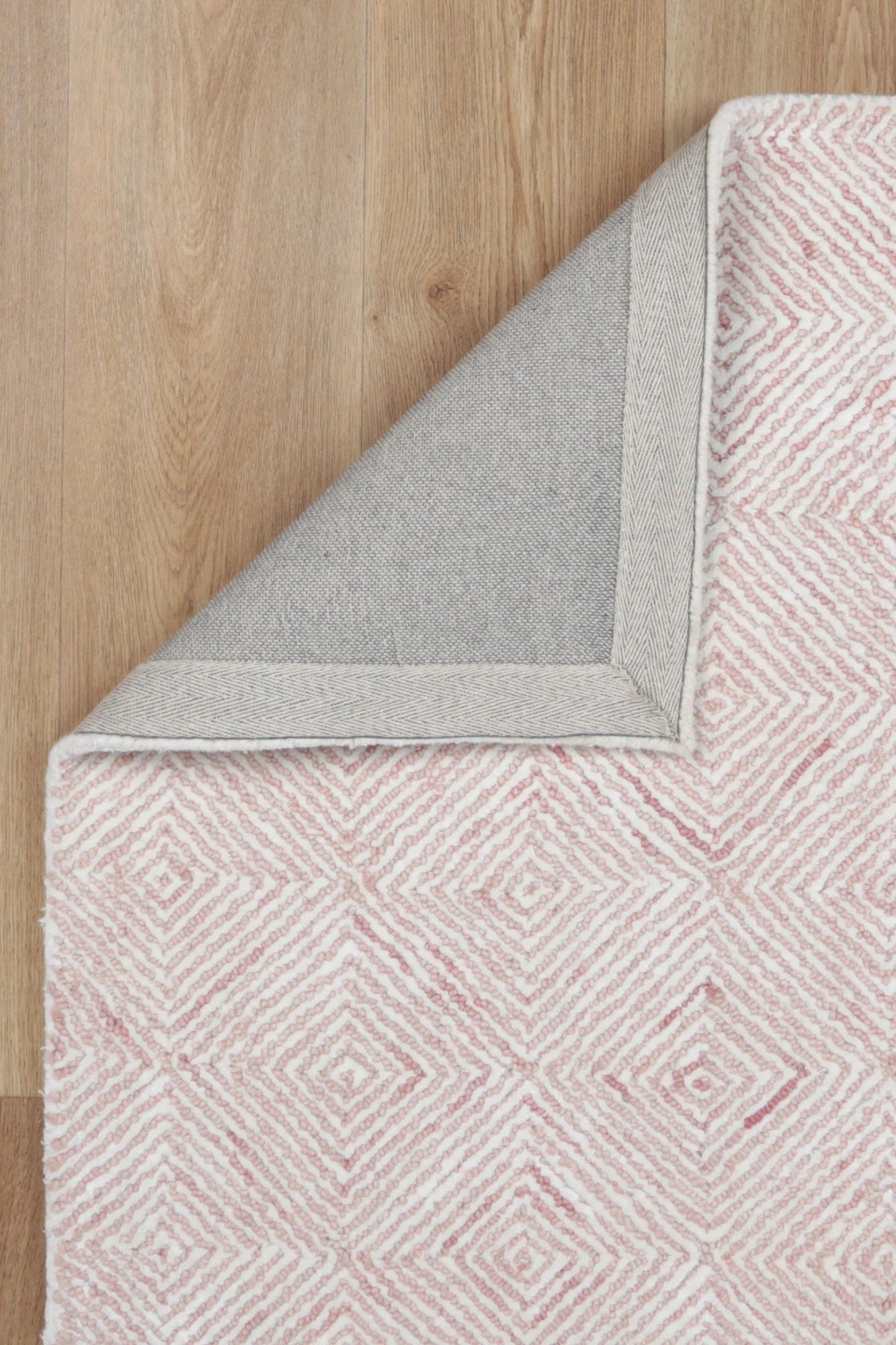 Zoomed-in view of the Astrid Rug's braided loop and viscose cut pile, highlighting the intricate craftsmanship.