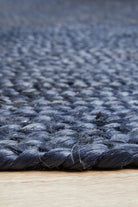 Close-up of a textured blue rug on a wooden floor