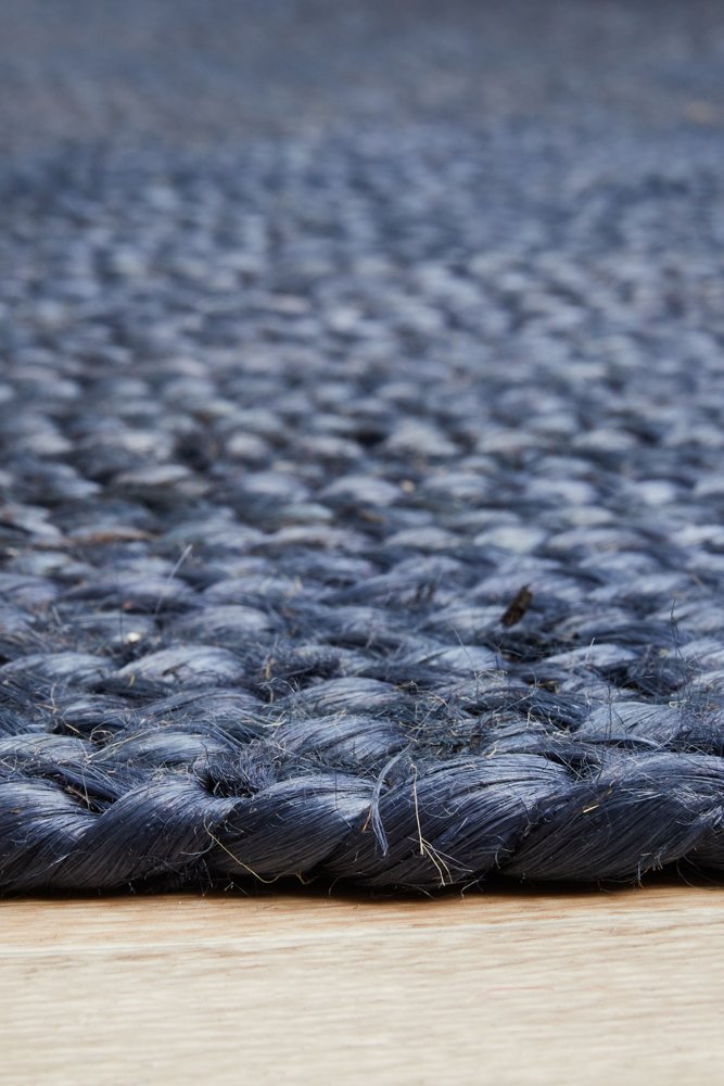 Close-up of a textured blue rug on a wooden floor
