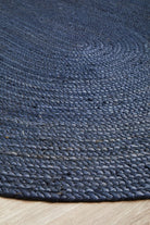 Close-up of a textured blue rug on a wooden floor