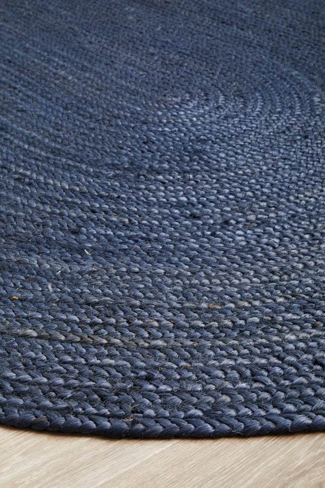 Close-up of a textured blue rug on a wooden floor